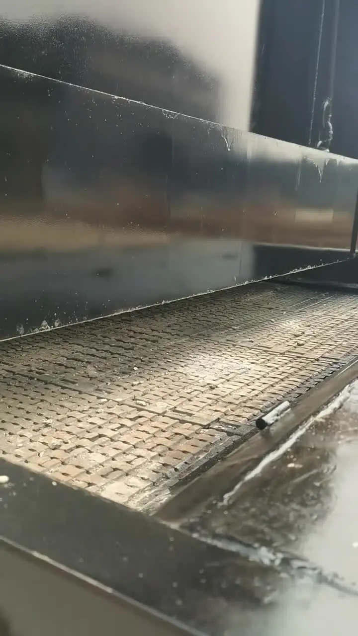 Close view of a chain-grate fuel feed and moving grate platform on a biomass boiler at JINHONG