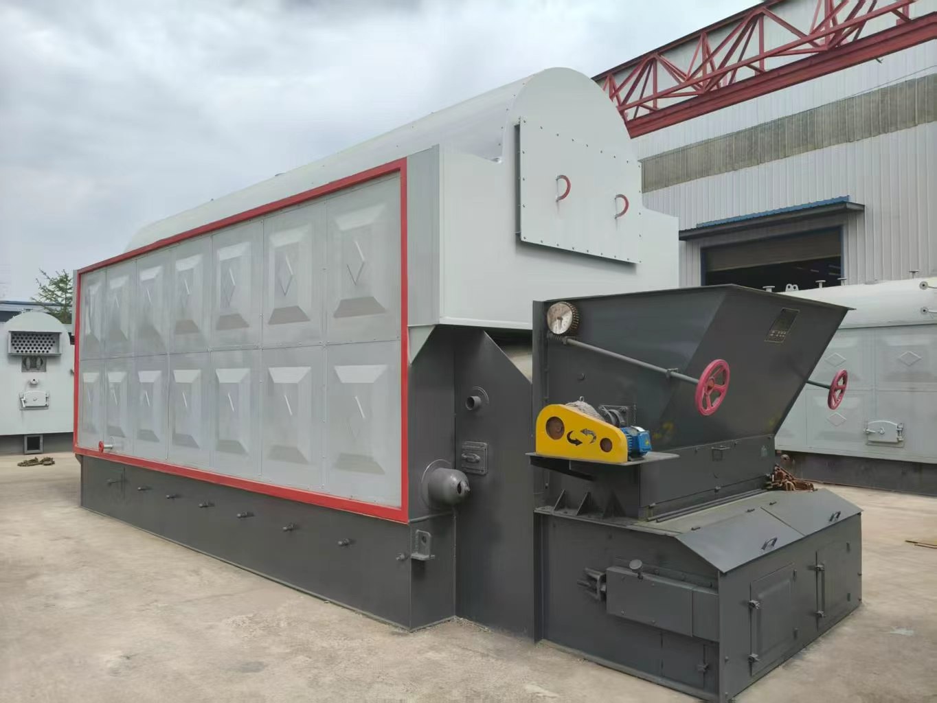 Industrial boiler with fuel hopper in the JINHONG factory yard