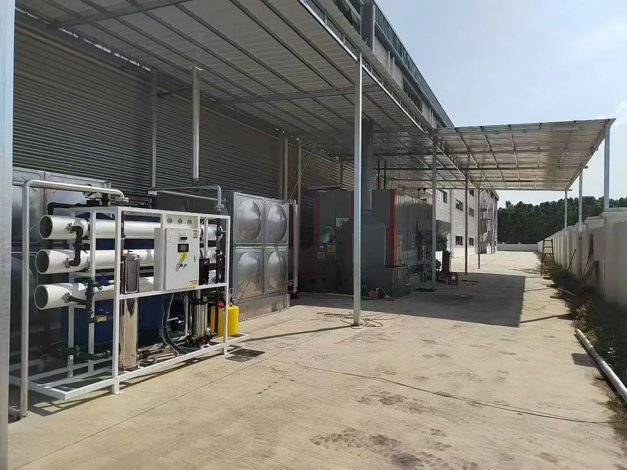 Wide view of the Bangladesh biomass steam system with reverse-osmosis water treatment and stainless feedwater tank