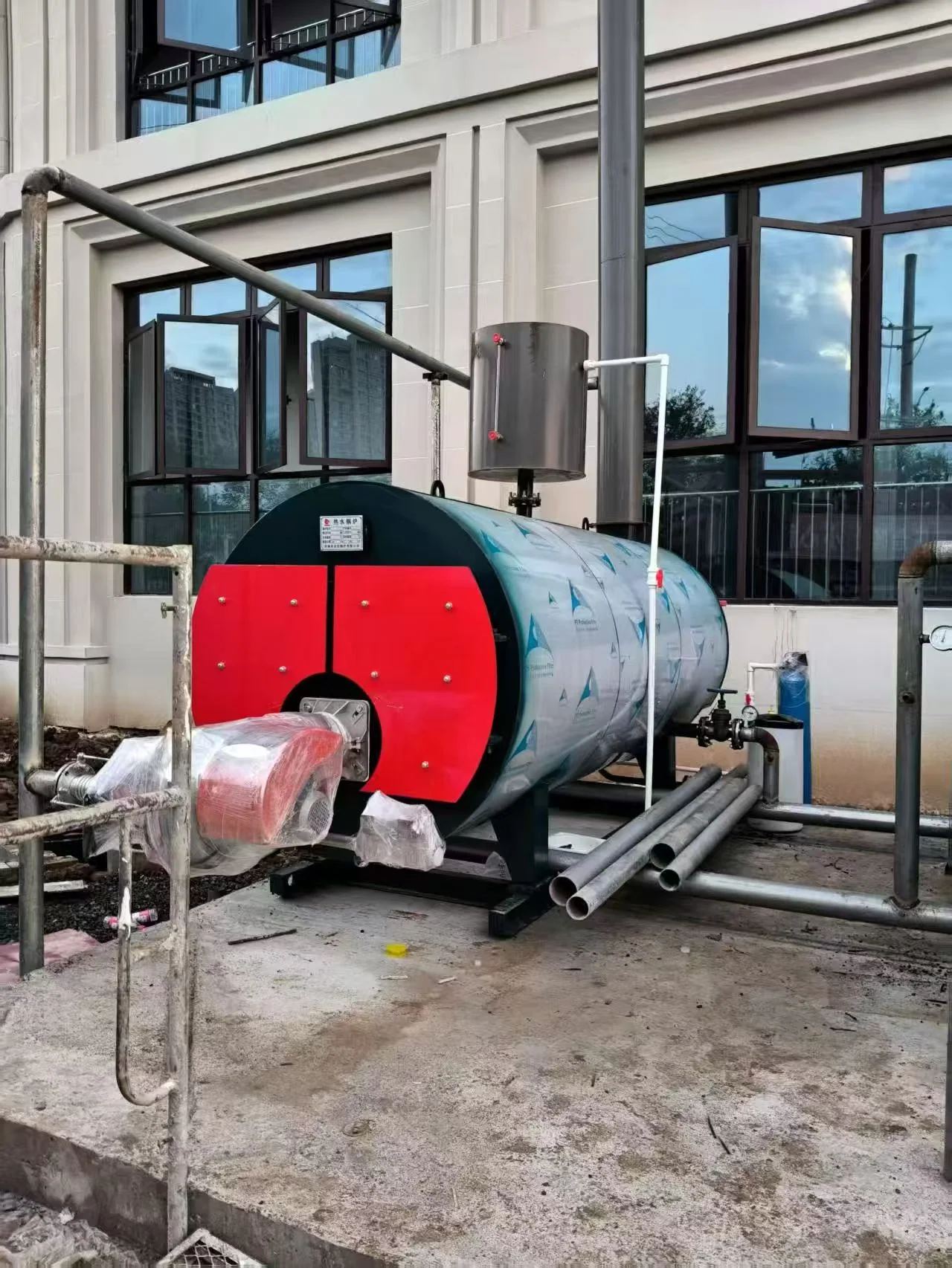 Single CWNS boiler with front-mounted burner and connected pipework during the Vietnam installation
