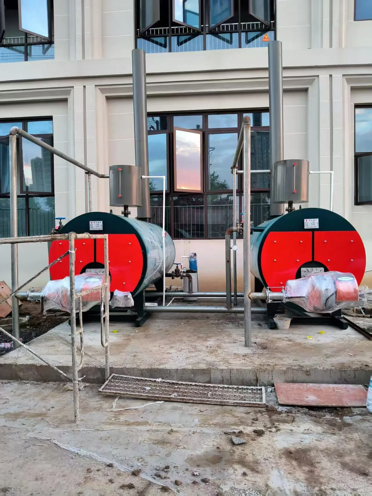 Two 1.4 MW CWNS natural gas hot water boilers during installation at the Vietnam building-heating project